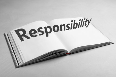 Roles and Responsibility concept. Open book on light gray tableの写真素材
