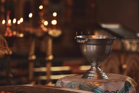 Silver vessel with holy water on stand in church, space for text. Baptism ceremonyの写真素材