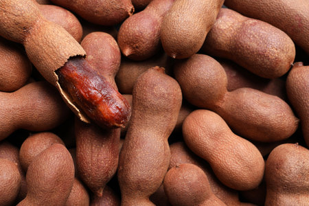 Delicious ripe tamarinds as background, closeup. exotic fruitsの写真素材