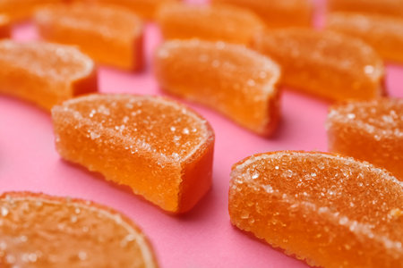 Delicious orange marmalade candies on pink background, closeupの写真素材