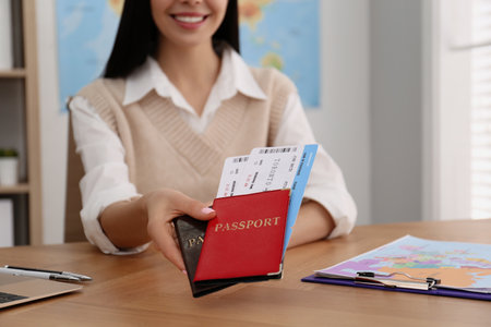 Travel agent with tickets and passports at table in office, closeupの写真素材