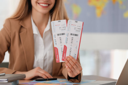 Travel agent with tickets at table in office, closeupの写真素材