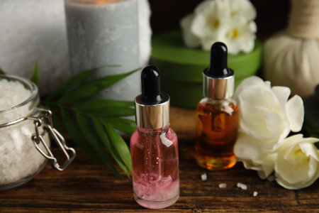 Bottles with essential oils on wooden table. spa productsの写真素材