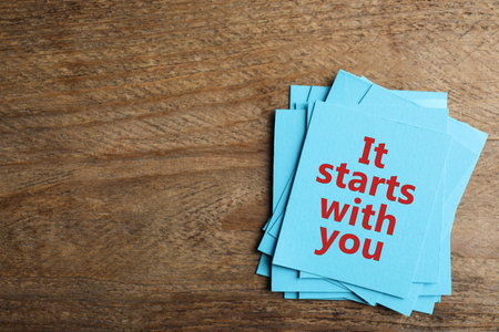 Roles and responsibilities concept. Blue paper cards with phrase It stars with you and space for text on wooden table, top viewの写真素材
