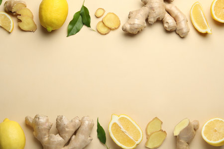 Fresh lemons and ginger on beige background, flat lay. Space for textの写真素材