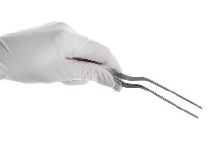Doctor holding surgical forceps on white background, closeup. medical instrumentsの写真素材