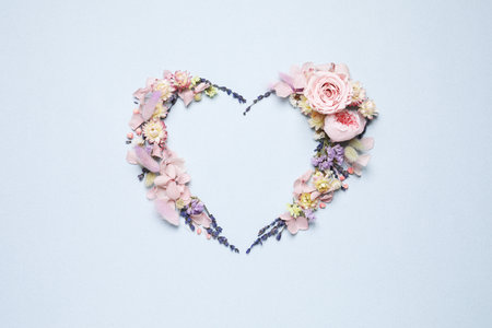 Beautiful heart shaped floral composition on light background, flat layの写真素材