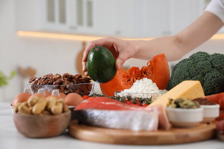 Woman and healthy food at white table, closeup. Keto dietの写真素材