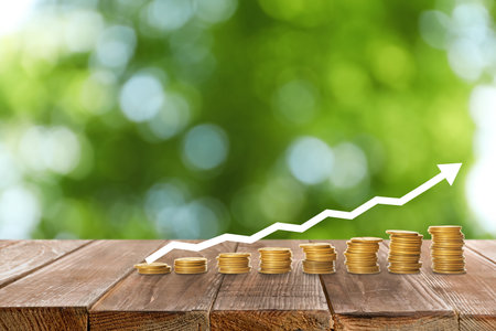 Stacked coins on wooden table against blurred background. investment conceptの写真素材