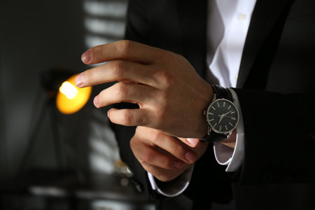 Businessman with luxury wrist watch indoors, closeupの写真素材
