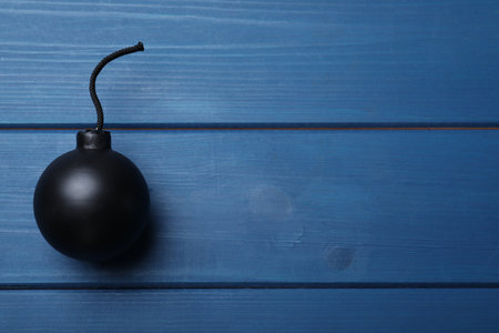 Old fashioned fuse bomb on blue wooden table, top view. Space for textの写真素材