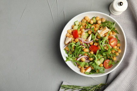 Delicious fresh chickpea salad served on light gray table, flat lay. Space for textの写真素材