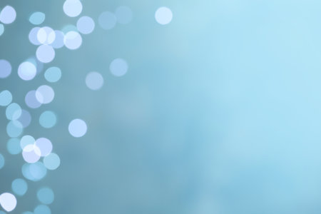 Blurred view of festive lights on light blue background, space for text. bokeh effectの写真素材
