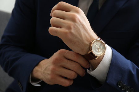 Businessman in jacket with luxury wrist watch, closeupの写真素材