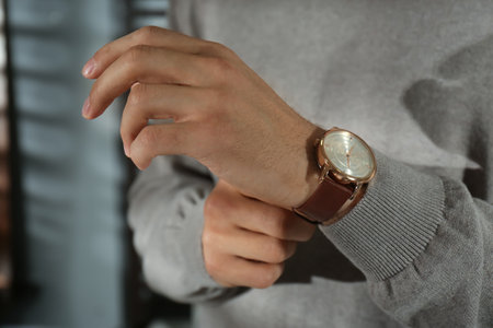 Man with luxury wrist watch on blurred background, closeupの写真素材