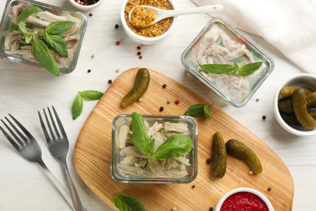 Delicious aspic and ingredients served on white wooden table, flat layの写真素材