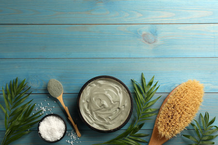 Flat lay composition with cosmetic product on light blue wooden background, space for text. Spa body wrapsの写真素材