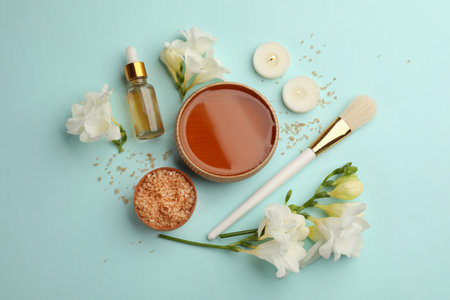 Flat lay composition with cosmetic product for spa body wraps on light blue backgroundの写真素材