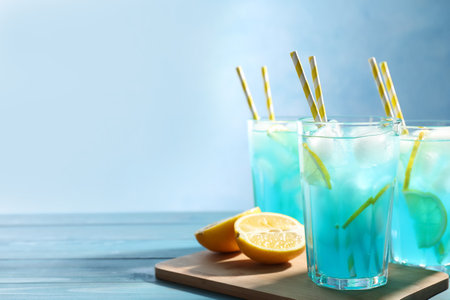 Delicious refreshing cocktail with ice on wooden table. Space for textの写真素材
