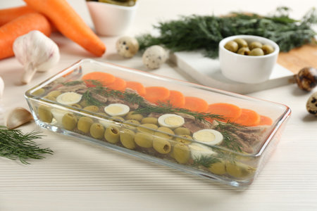 Delicious aspic with meat in glass dish on white wooden tableの写真素材