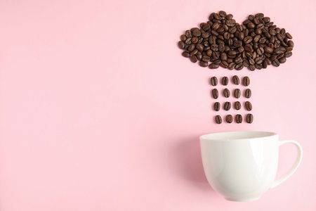 Cloud and raindrops made of coffee beans falling into cup on pink background, flat lay. Space for textの写真素材