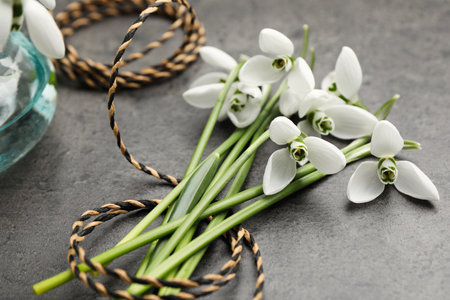 Beautiful snowdrops and twine on gray table. spring flowersの写真素材