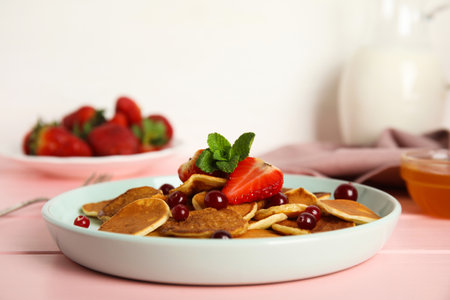 Cereal pancakes with berries on pink wooden tableの写真素材
