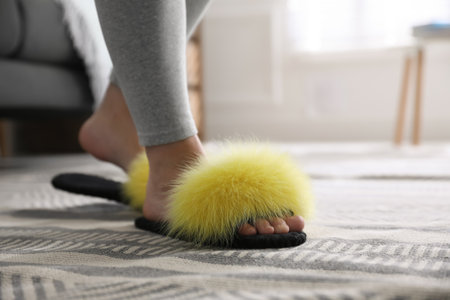 Woman wearing stylish soft slippers at home, closeupの写真素材