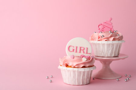 Baby shower cupcakes with toppers on pink background, space for textの写真素材