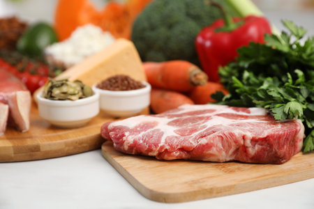 Fresh meat and parsley on white table, space for text. Keto dietの写真素材