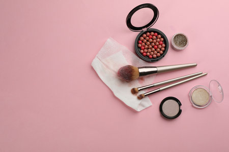 Dirty wet wipe, brushes and cosmetic on light pink background, flat lay. Space for textの写真素材