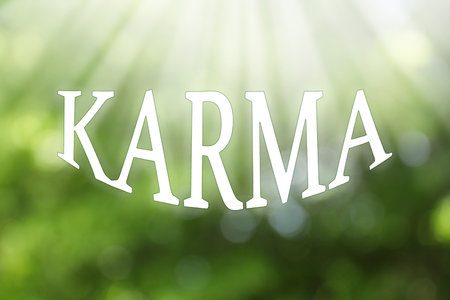 Word KARMA on blurred green background, bokeh effectの写真素材