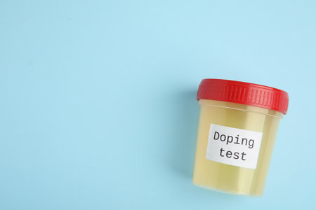 Top view of jar with urine sample on light blue background, space for text. doping controlの写真素材