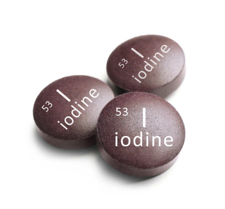 Iodine pills on white background. mineral elementの写真素材