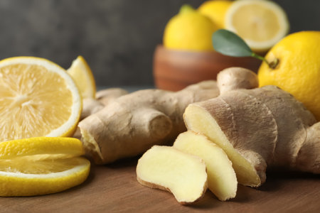 Cut ginger and lemon on wooden board, closeupの写真素材