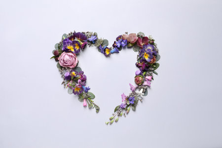 Beautiful heart shaped floral composition on light background, flat layの写真素材