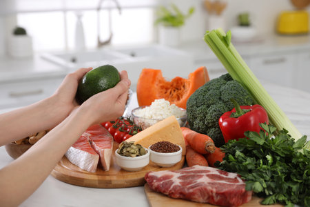 Woman and healthy food at white table, closeup. Keto dietの写真素材
