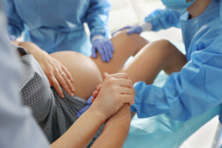 Woman giving child birth in maternity hospital, closeupの写真素材