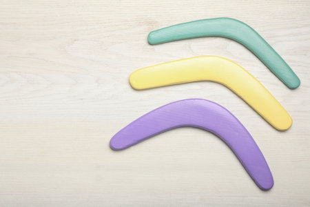 Boomerangs on white wooden background, flat lay. Space for textの写真素材