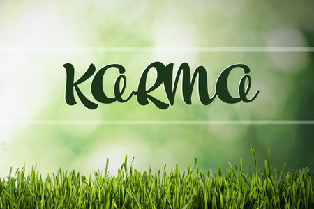 Word KARMA on blurred green background, bokeh effectの写真素材