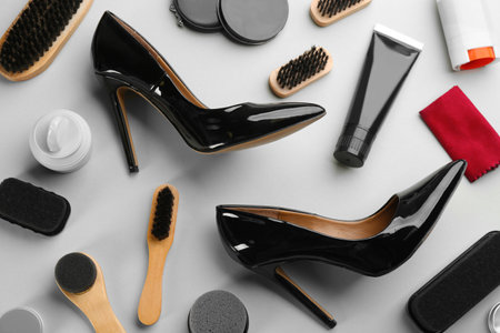 Flat lay composition with shoe care accessories and footwear on light grey backgroundの写真素材