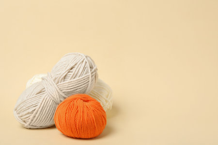 Soft woolen yarns on beige background, space for textの写真素材