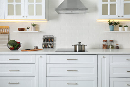Elegant kitchen interior with modern stove and stylish furniture