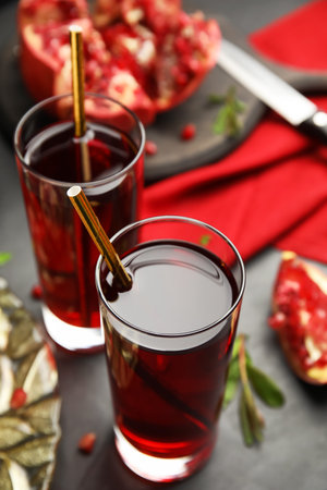 Pomegranate juice and fresh fruits on black tableの写真素材