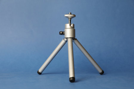 Modern stylish mobile tripod on blue backgroundの写真素材