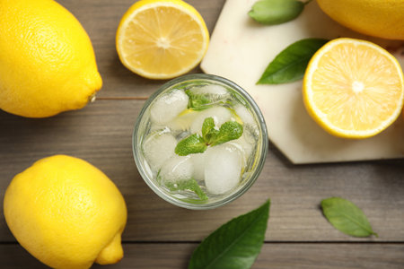 Cool freshly made lemonade and fruits on wooden table, flat layの写真素材