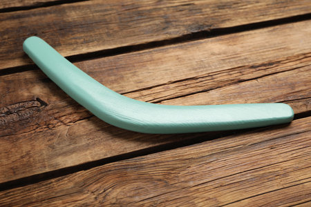 Turquoise boomerang on wooden background. outdoor activityの写真素材