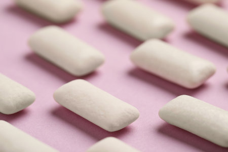 Many chewing gum pieces on pink background, closeupの写真素材