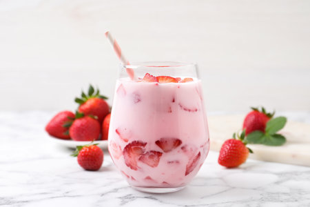 Delicious drink with strawberries on white marble tableの写真素材