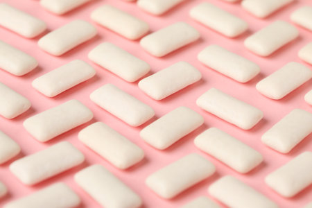 Many chewing gum pieces on pink background, closeupの写真素材